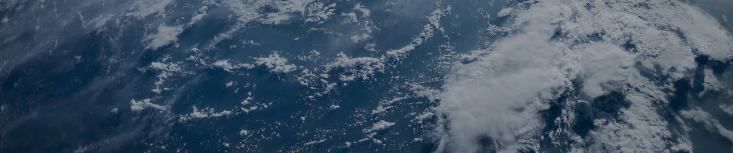 Aerial shot of ocean with clouds above